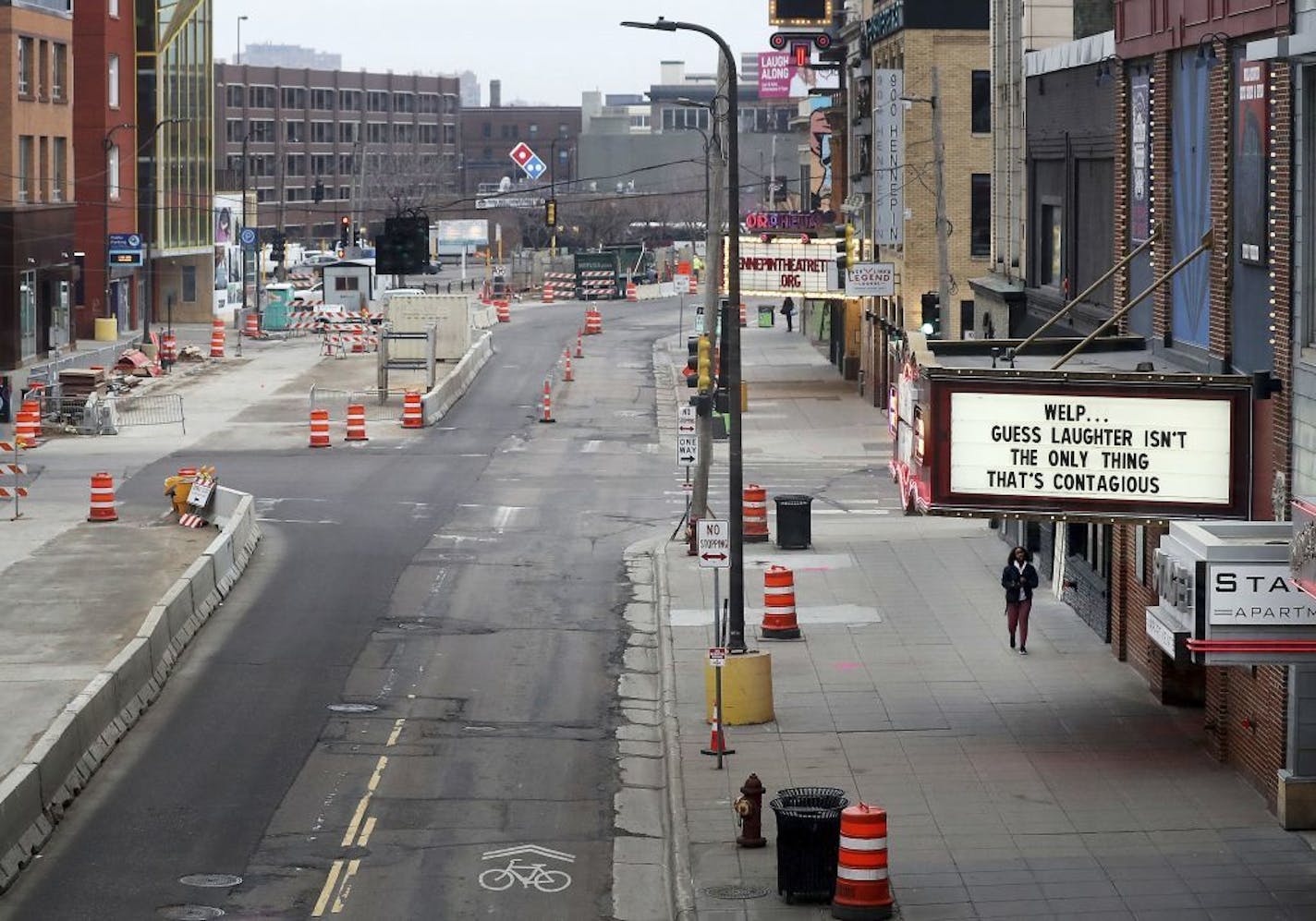 Traffic in the theater district was light as the marquee message above Brave New Workshop on Hennepin Avenue offers a light message in the face of the coronavirus pandemic, on March 18, 2020, in Minneapolis.