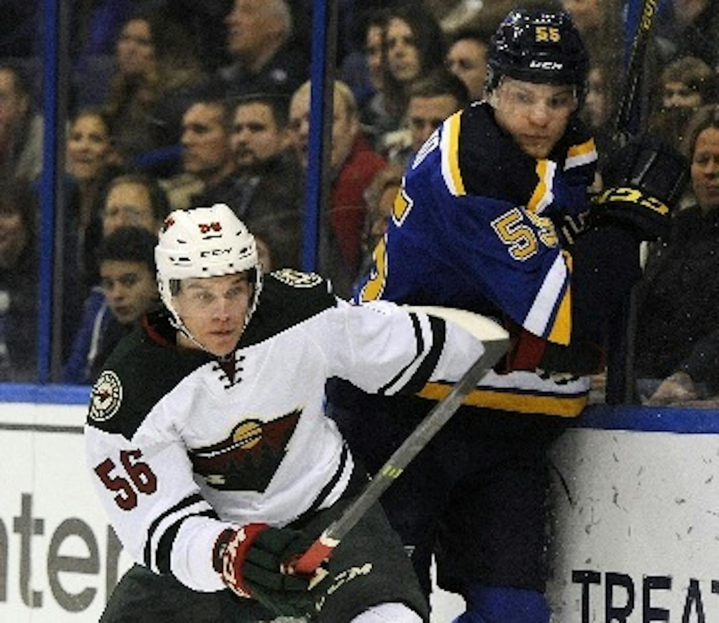 The Blues' Colton Parayko is checked by the Wild's Erik Haula during the first period Thursday.