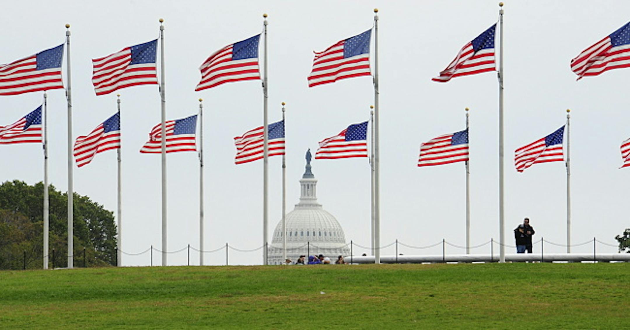 Tourists walk near the Washington Monument on October 8, 2008. The US Capitol can be seen in the background. The White House announced Wednesday that it will host a summit on development on October 21, saying the global economic crisis made such aid "more important now than ever." US President George W. Bush and US Secretary of State Condoleezza Rice will address the gathering, officially named "White House Summit on International Development: Sustaining the New Era," said spokeswoman Dana Perin