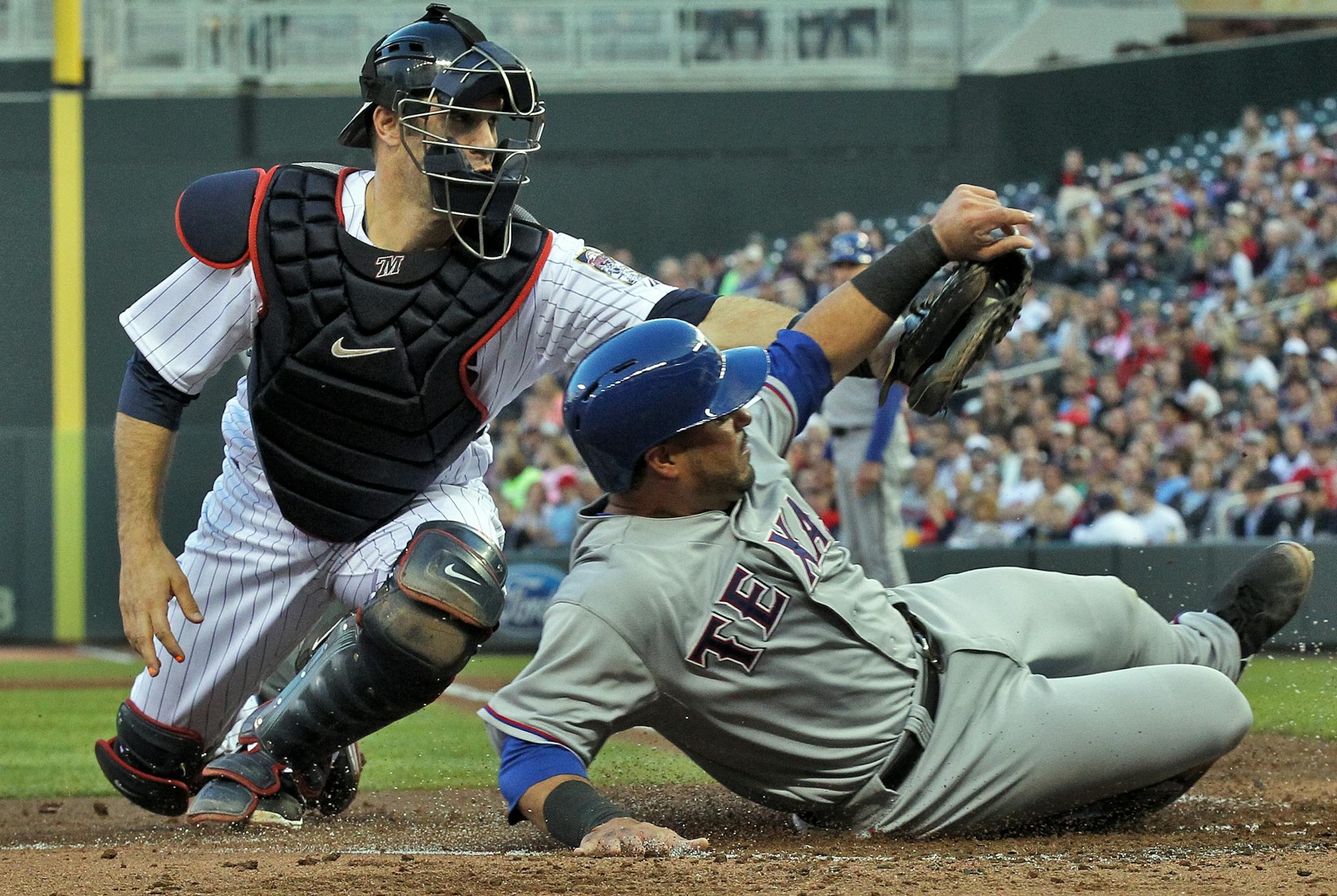 Twins catcher Joe Mauer tagged out Texas base runner Geovany Soto at home in April.