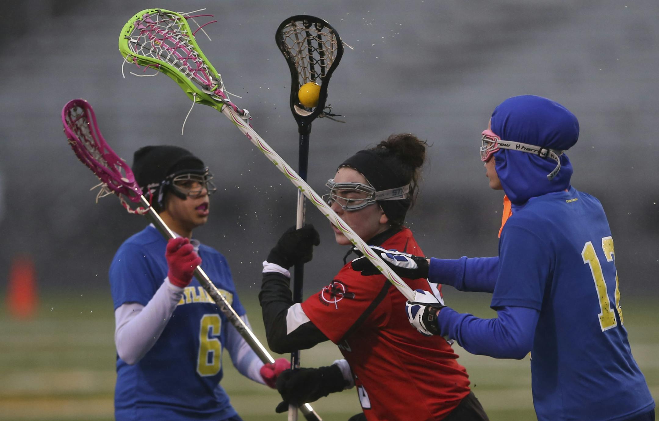 Minneapolis Lacrosse defeated Columbia Heights 19-6 on a cold and rainy Wednesday night, April 17, 2013 at Washburn High School Field in Minneapolis, Minn. Minneapolis Lacrosse's Eden Rosenbloom slipped between the defense of Columbia Heights' Salena Abram, left, and Mariah Hanson in the first half Wednesday night. ] JEFF WHEELER ‚Ä¢ jeff.wheeler@startribune.com