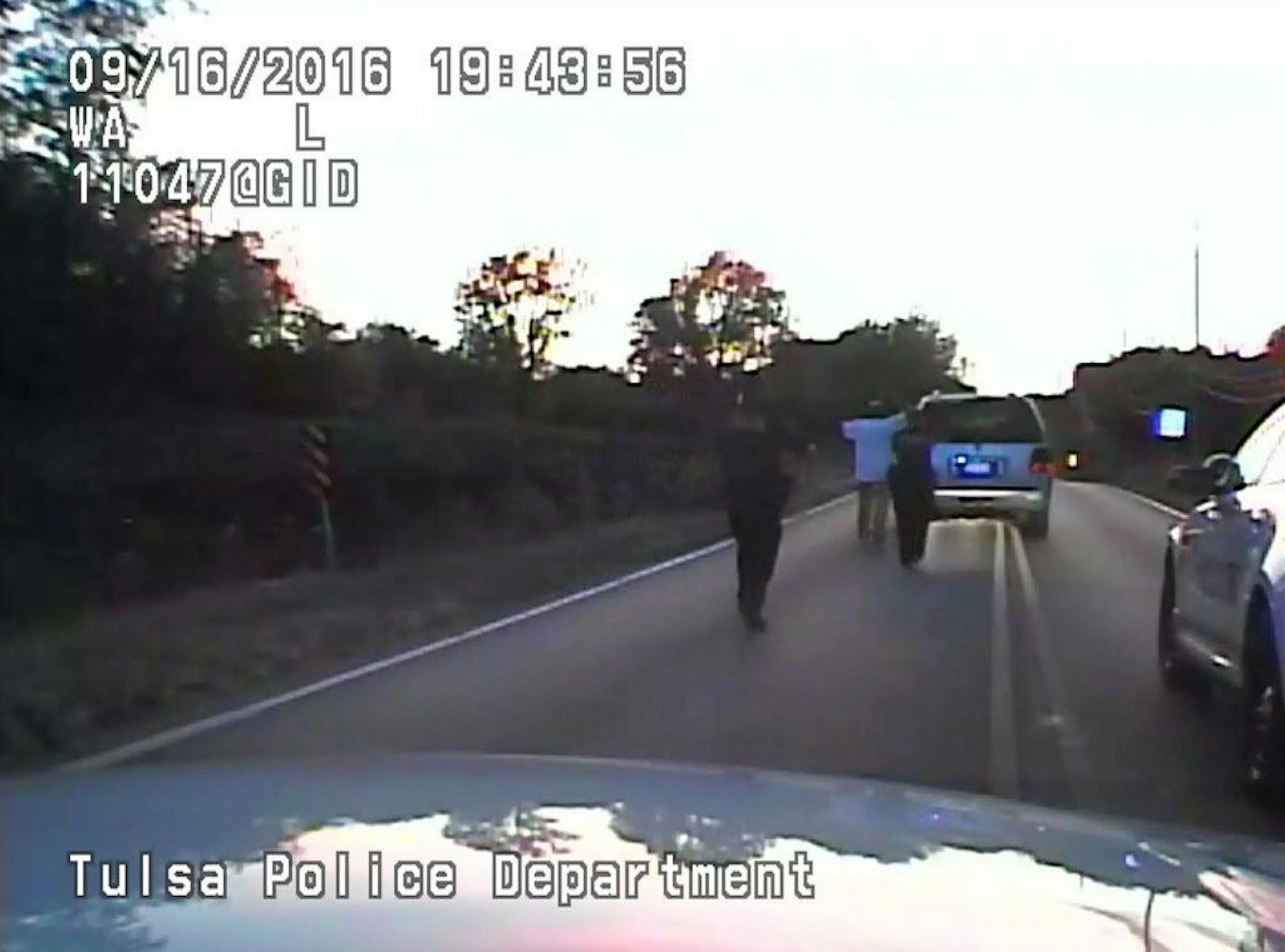 In this image made from a Friday, Sept. 16, 2016 police video, Terence Crutcher, center, is pursued by police officers as he walk to an SUV in Tulsa, Okla. Crutcher was taken to the hospital where he was pronounced dead after he was shot by the officer around 8 p.m., Friday, police said. Crutcher had no weapon on him or in his SUV, Tulsa Police Chief Chuck Jordan said Monday, Sept. 19, 2016.