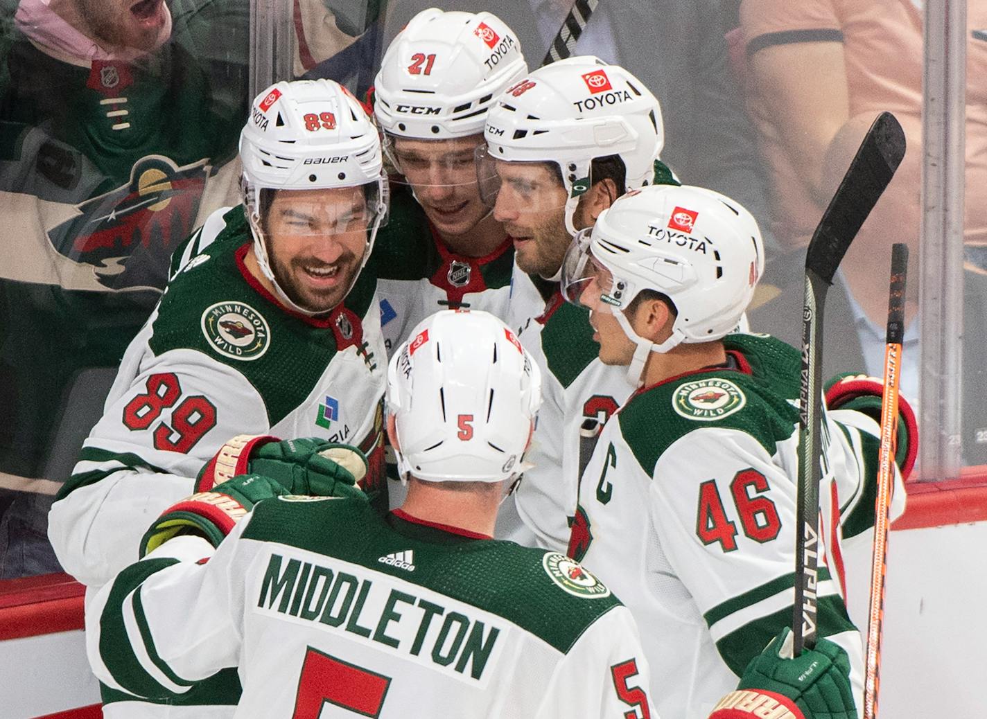 Minnesota Wild's Brandon Duhaime (21) celebrates with teammates after scoring against the Montreal Canadiens during the second period of an NHL hockey game, Tuesday, Oct. 25, 2022 in Montreal. (Graham Hughes/The Canadian Press via AP)