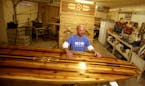 Tim Shore custom makes stand up paddle boards from wood and will be exhibiting his useable art at the upcoming Minneapolis Boat Show. Here, Shore was 