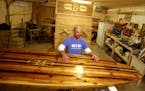 Tim Shore custom makes stand up paddle boards from wood and will be exhibiting his useable art at the upcoming Minneapolis Boat Show. Here, Shore was 