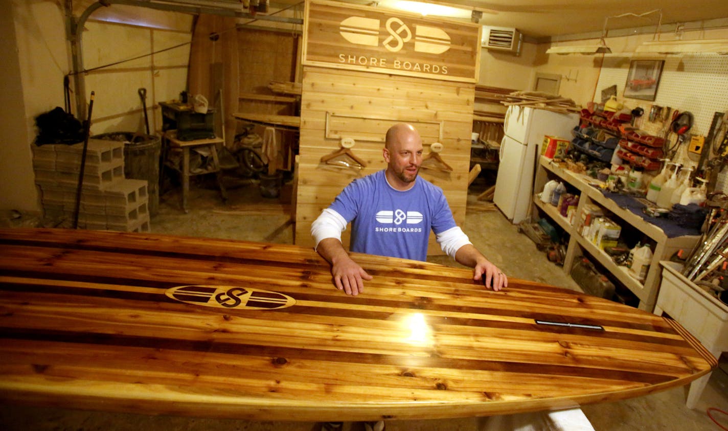 Tim Shore custom makes stand up paddle boards from wood and will be exhibiting his useable art at the upcoming Minneapolis Boat Show. Here, Shore was seen in the garage where his is building a 10 1/2 footer, featuring a laser-cut logo.