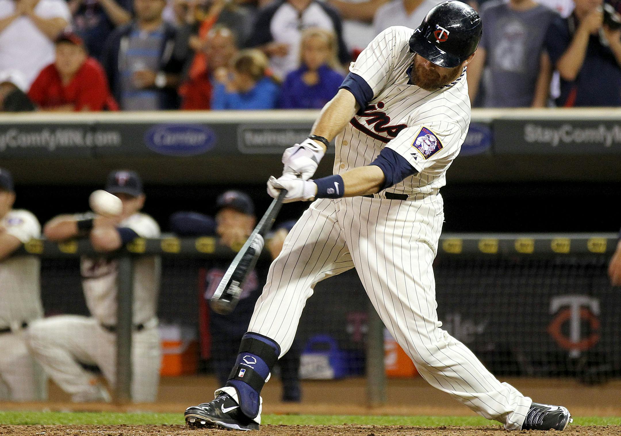 Minnesota Twins' Ryan Doumit hits the go-ahead single off Houston Astros pitcher Lucas Harrell in the sevetnh inning of their baseball game won by the Twins 6-4 in Minneapolis, Saturday, Aug. 3, 2013.(AP Photo/Andy Clayton-King)