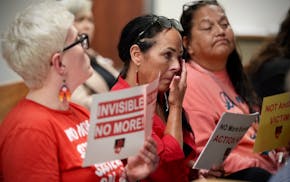 Allison Lussier’s aunt Jana Williams, center, tears up while members of advocacy groups update Minneapolis City Council members on how the police de