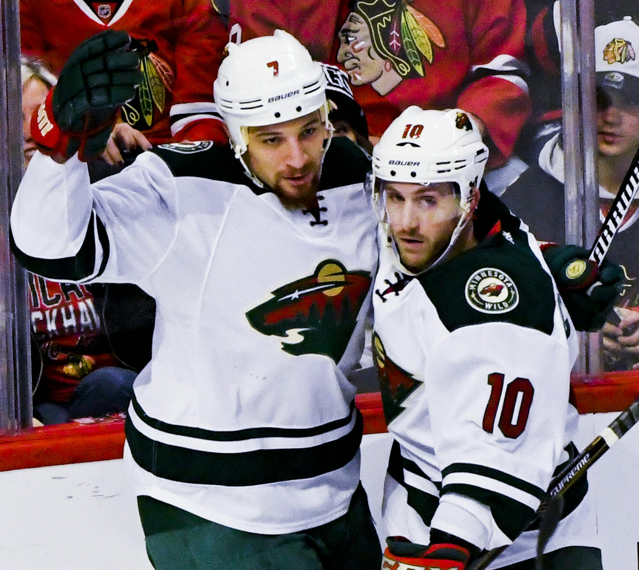 Minnesota Wild right wing Chris Stewart (7) celebrates his goal against the Chicago Blackhawks with center Jordan Schroeder (10) and center Tyler Graovac (44) during the second period of an NHL hockey game on Sunday, Jan. 15, 2017, in Chicago. (AP Photo/Matt Marton)