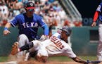 Minnesota Twins' Byron Buxton (25) is called safe at third base on a triple as Texas Rangers' Asdrubal Cabrera applied the tag in the second inning.