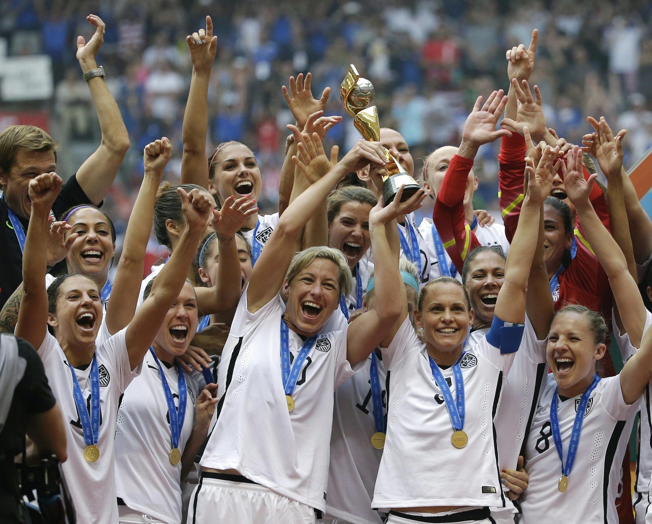 In this July 5, 2015, file photo, the United States women's national team celebrated with the trophy after they beat Japan 5-2 in the FIFA Women's World Cup soccer championship in Vancouver, British Columbia, Canada. Five players from the World Cup-winning U.S. national team have accused the U.S. Soccer Federation of wage discrimination in an action filed with the Equal Employment Opportunity Commission. Alex Morgan, Carli Lloyd, Megan Rapinoe, Becky Sauerbrunn and Hope Solo maintain in the EEOC