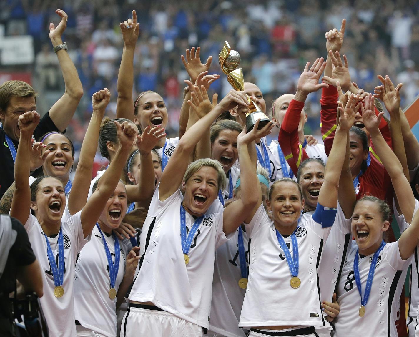 In this July 5, 2015, file photo, the United States women's national team celebrated with the trophy after they beat Japan 5-2 in the FIFA Women's World Cup soccer championship in Vancouver, British Columbia, Canada. Five players from the World Cup-winning U.S. national team have accused the U.S. Soccer Federation of wage discrimination in an action filed with the Equal Employment Opportunity Commission. Alex Morgan, Carli Lloyd, Megan Rapinoe, Becky Sauerbrunn and Hope Solo maintain in the EEOC