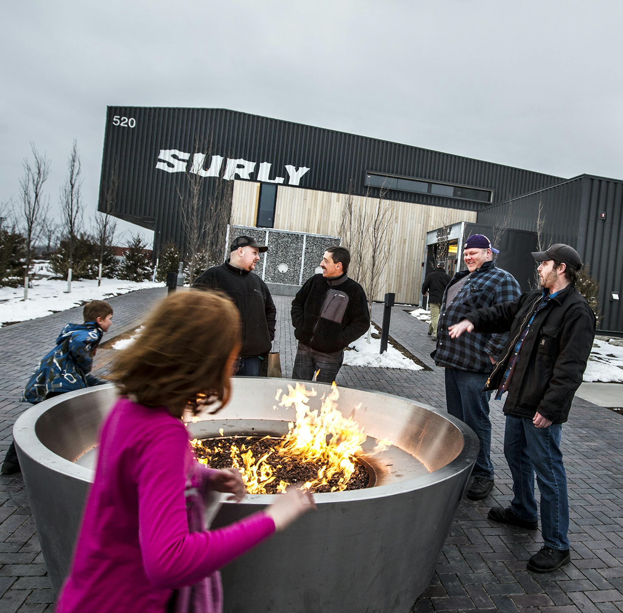 Right to left, Brian Tome and Lee Jerich of Ely stand by the fire with Chris Lang of Stillwater and Phil Meyer of Maplewood at Surly Brewing Co. in Minneapolis March 23, 2015. (Courtney Perry)