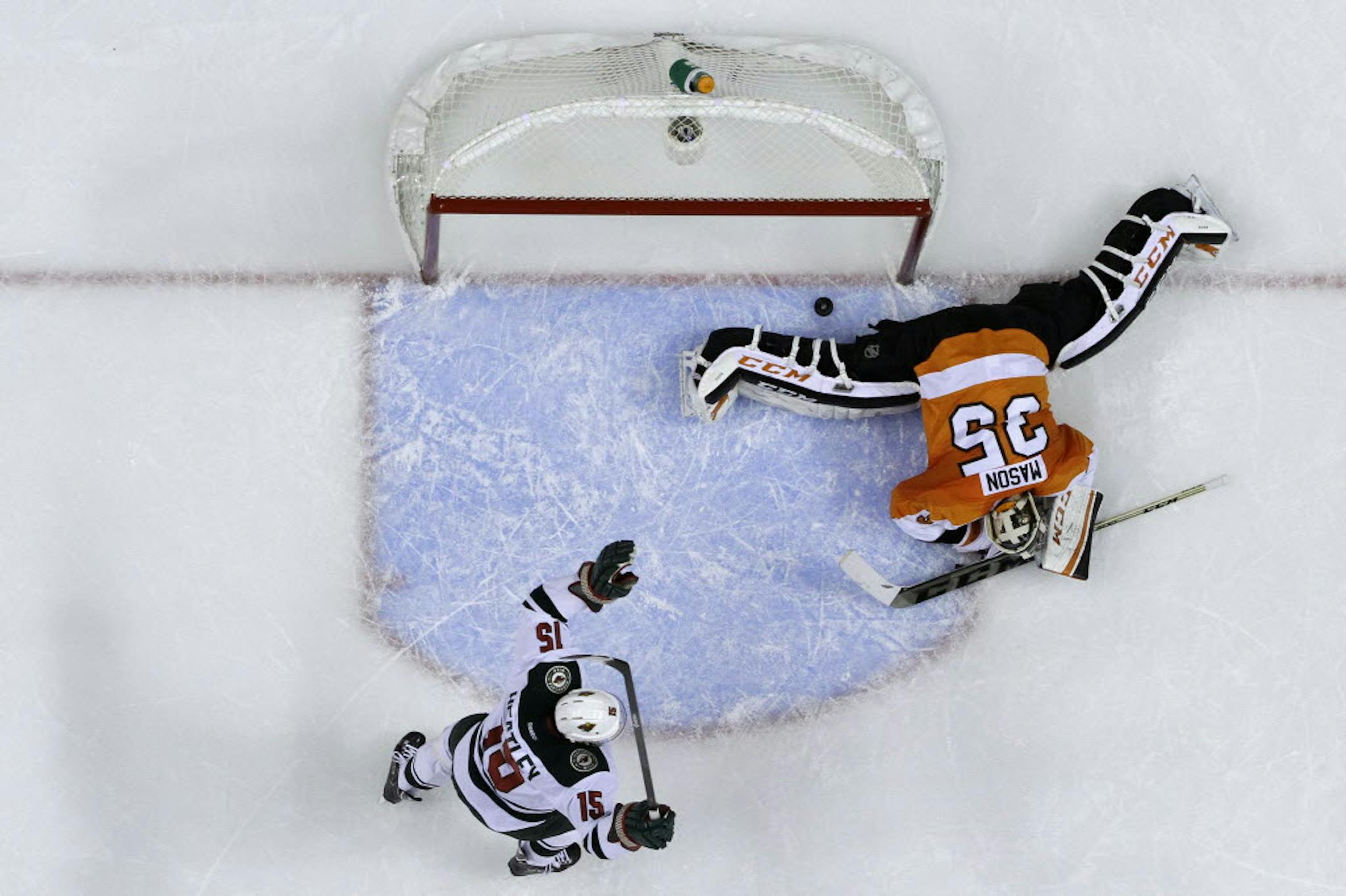 Minnesota's Dany Heatley (15) celebrates after teammate Mikael Granlund scored against Philadelphia's Steve Mason.