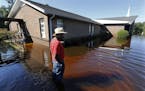 Harold Ancrum, a church member at Canaan United Methodist Church, checks on the floodwaters at the church near Summerville, S.C., Thursday, Oct. 8, 20