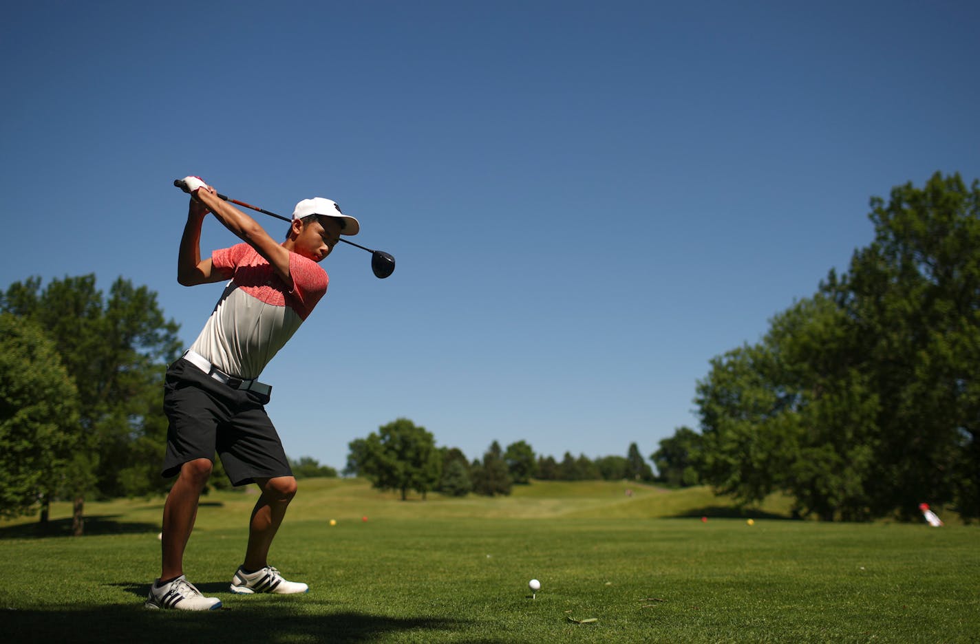 North St. Paul junior Logan Xiong teeing off on the third hole during a round with teammates at Manitou Ridge in White Bear Lake (Jeff Wheeler, Star Tribune)