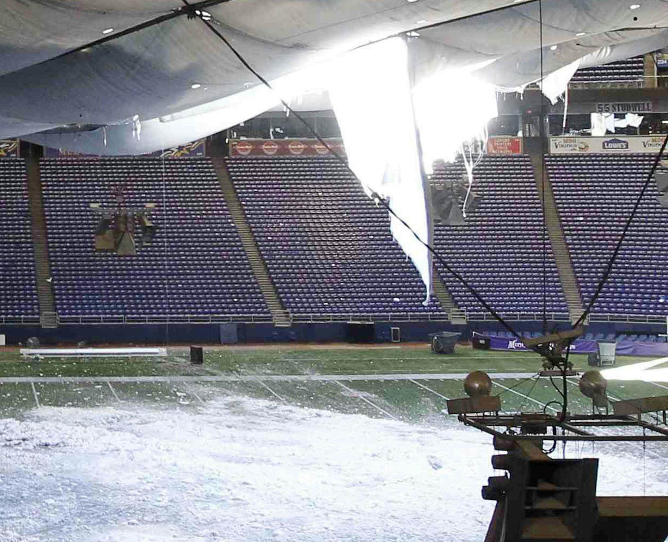 FILE - In this Dec. 12, 2010, file photo, snow falls into the field from a hole in the collapsed roof of the Metrodome in Minneapolis. The landlords of the Metrodome voted unanimously Thursday, Feb. 10, 2011, to replace the snow-damaged roof of the venerable stadium, opting for a more time-consuming fix that could disrupt the Minnesota Vikings preseason schedule. (AP Photo/Ann Heisenfelt, File) ORG XMIT: MIN2013121717125364