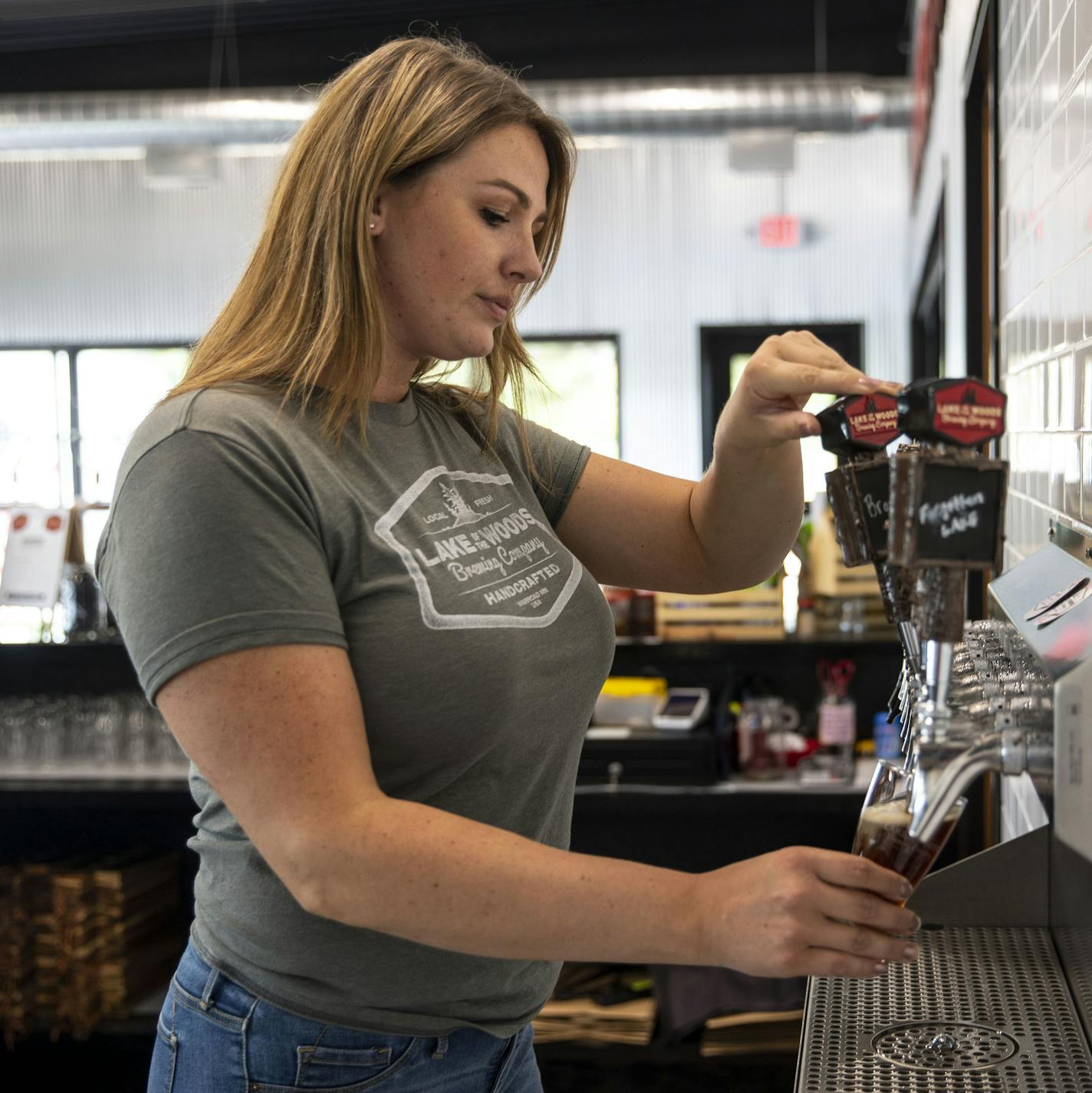 Nicole Olson, general manager of Lake of the Woods Brewing Co. in Minnesota, poured a glass of one of their home-brewed beers. This is the north-most brewery in the continental US.]
ALEX KORMANN &#x2022; alex.kormann@startribune.com Warroad, MN is Minnesota's north-most town, about five miles from the Canadian border. Recently it has seen some economic hardships but those have been continuously met with community members working hard to create innovative ways to rejuvenate the economy and bring