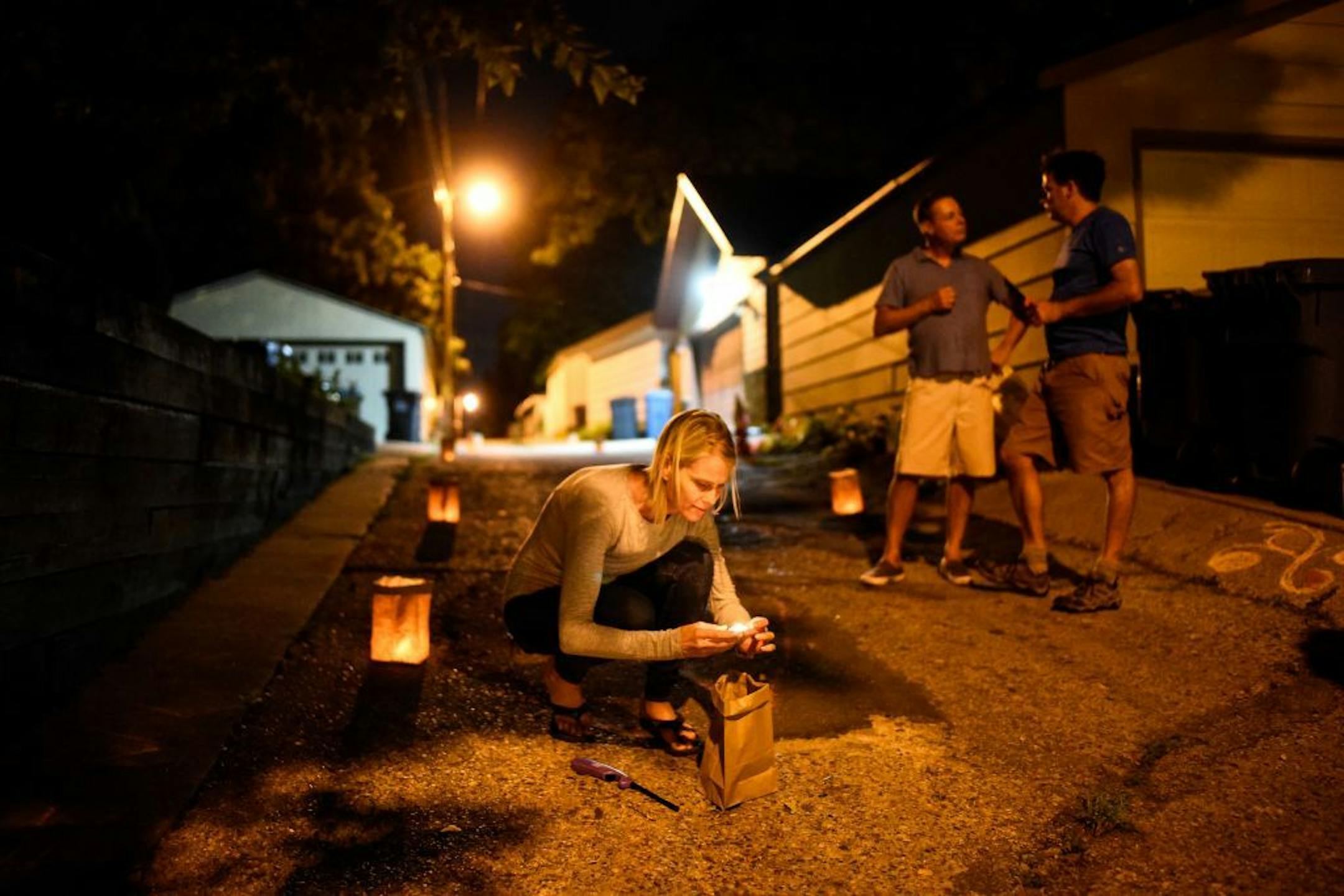 Mindy Barry, a neighbor of Don Damond, lit a luminary near where Justine Damond Ruszczyk was shot and killed one year ago by Minneapolis Police officer Mohamed Noor.