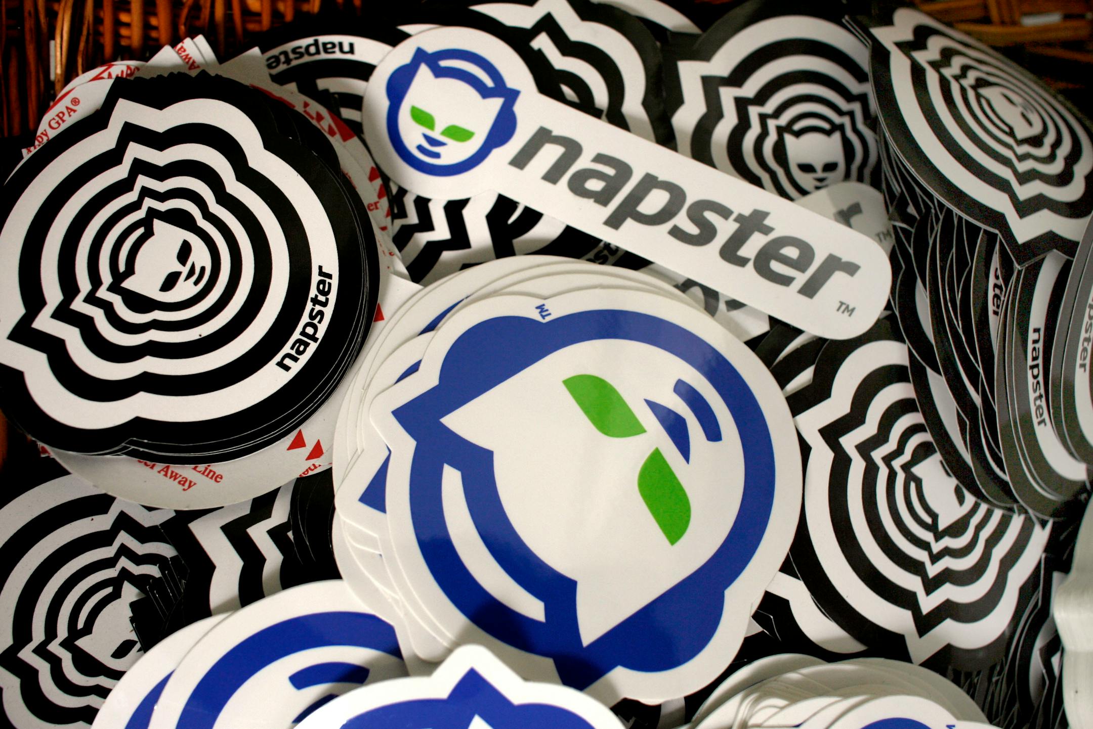 In this Aug. 2, 2006 file photo, promotional Napster stickers are seen at the Napster studio in Los Angeles. Napster Inc., the online music community that rose from a dorm room project to became the scourge of the global recording industry, is being purchased by Best Buy Inc. for nearly $127 million as the electronics retailer tries to boost its digital music business, it was announced Monday, Sept. 15, 2008.