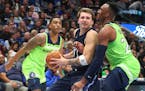 Dallas forward Luka Doncic tried to get past Timberwolves guard Josh Okogie for a shot in the second quarter.