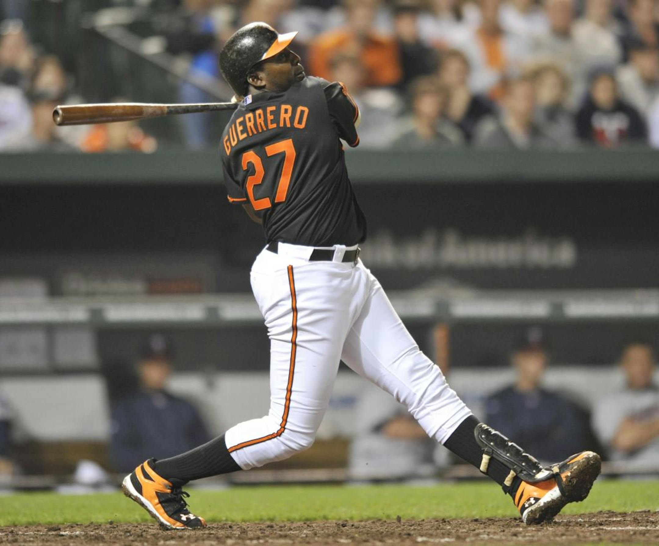 Baltimore Orioles' Vladimir Guerrero follows through on a three-run home run against the Minnesota Twins during the eighth inning of a baseball game Tuesday, April 19, 2011, in Baltimore. The Orioles won 11-0.