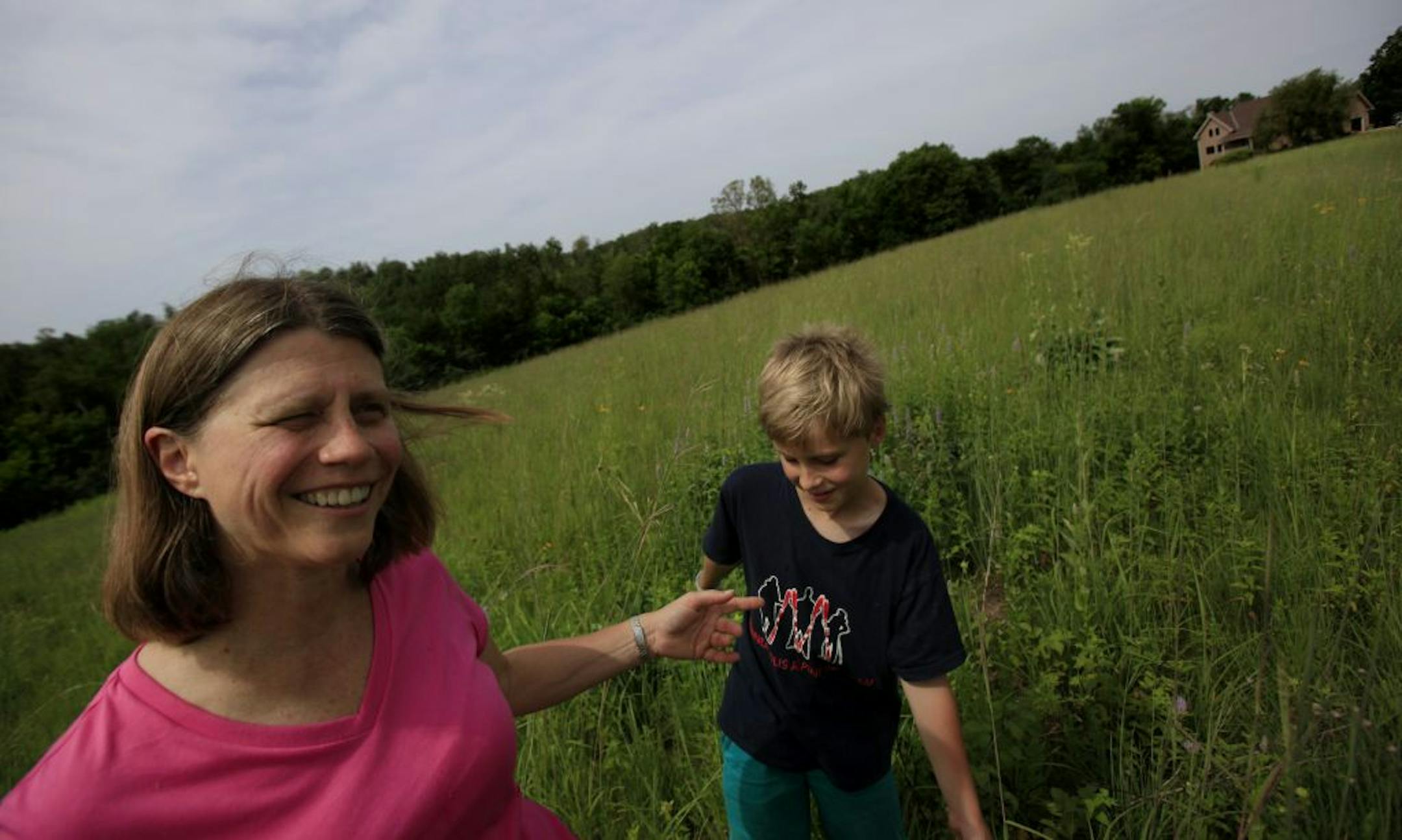 Dr. Elizabeth Reeve and her son Luke in the prairie garden.