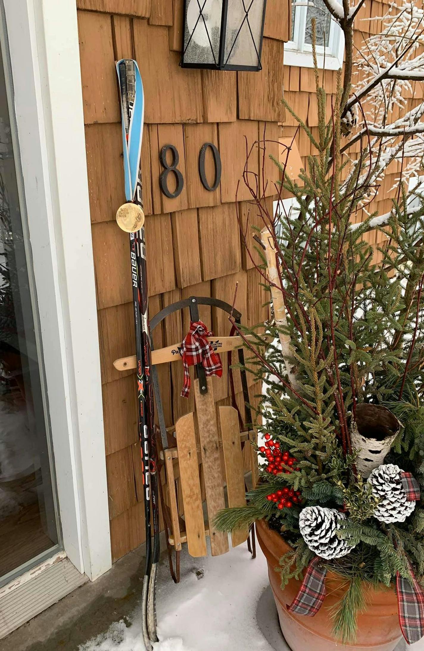 The Olympic gold medal of legendary hockey coach Herb Brooks put his Olympic gold medal, along with hockey sticks, outside in tribute to youth hockey player Marshall Bader. ORG XMIT: HPsK0i4xPQzCrlde7NoK