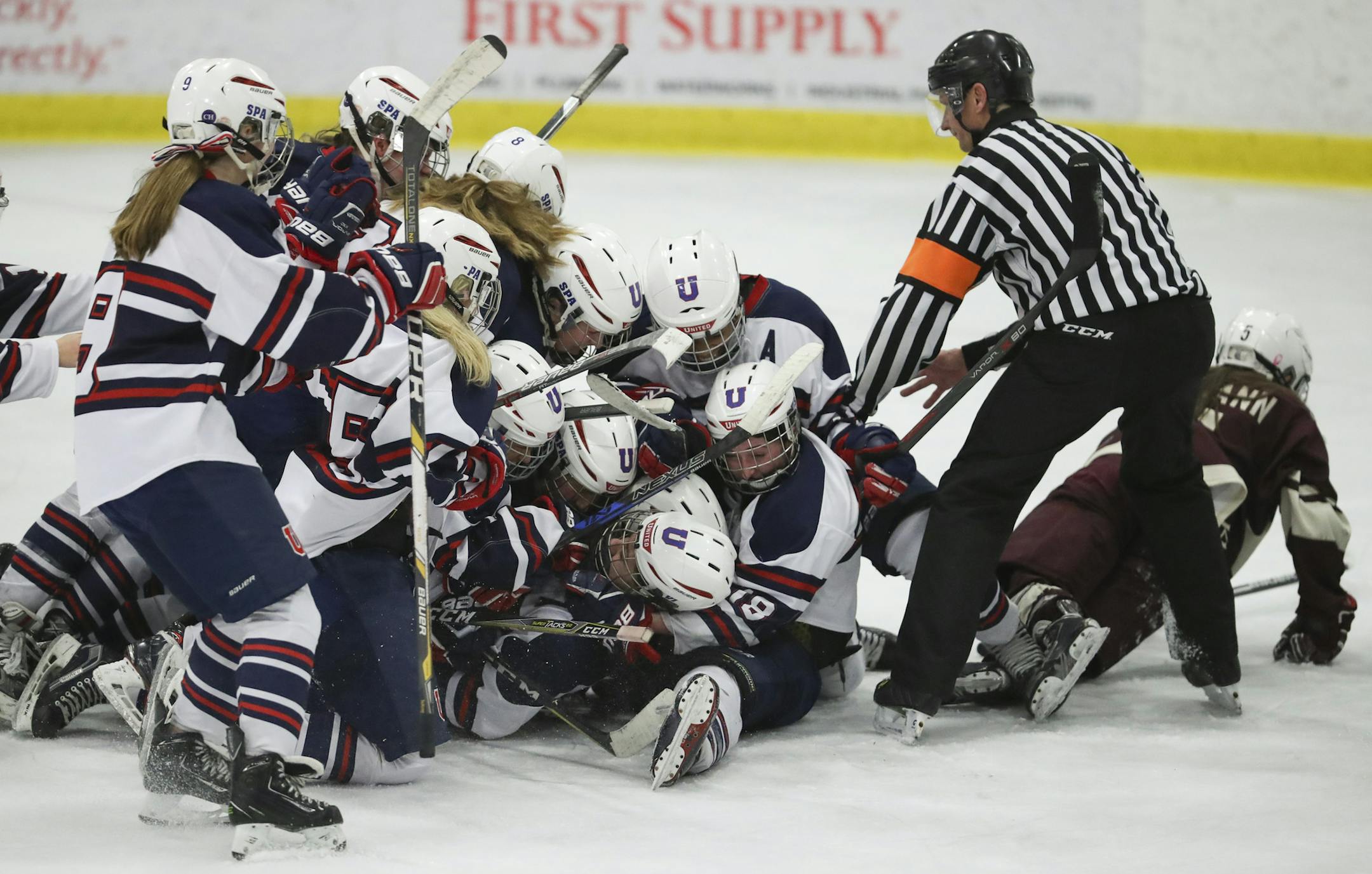 St. Paul United teammates smothered Catherine Kerin after she scored the winning goal in overtime against South St. Paul. ] JEFF WHEELER ï jeff.wheeler@startribune.com St. Paul United beat South St. Paul 2-1 in overtime to win the girls' Class 1A, Section 4 Championship Thursday night, February 15, 2018 at Doug Woog Arena in South St. Paul.