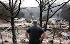 Chris Lacombe looks over the remains of his home, which was destroyed by the LNU Lightning Complex, in Spanish Flat, Calif., on Aug. 25, 2020.