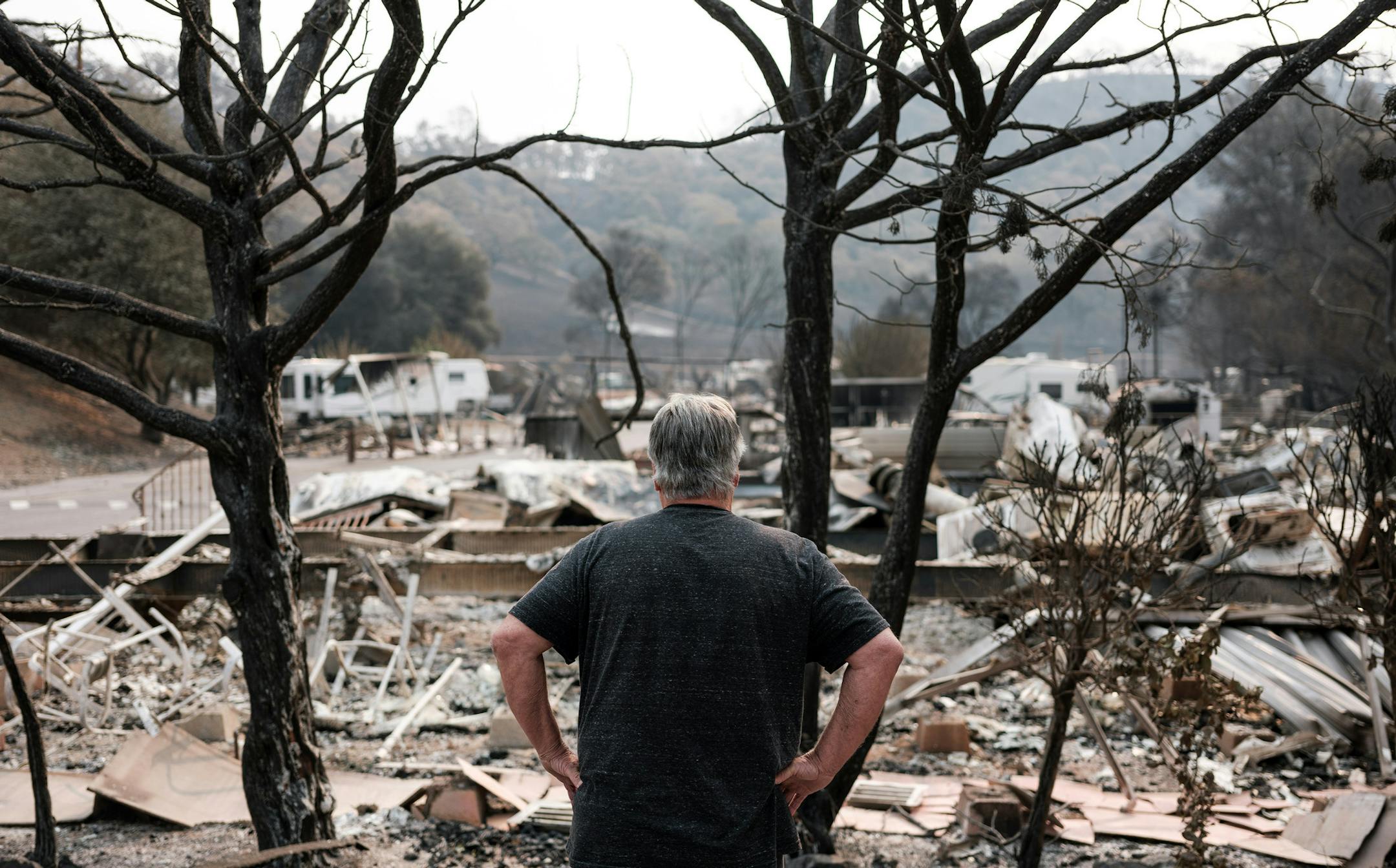 Chris Lacombe looks over the remains of his home, which was destroyed by the LNU Lightning Complex, in Spanish Flat, Calif., on Aug. 25, 2020.