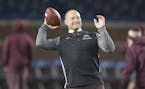 Minnesota Head Coach P. J. Fleck passed the ball a bit with his wife Heather Fleck before the Gophers took on Michigan in Michigan Stadium, Saturday, 