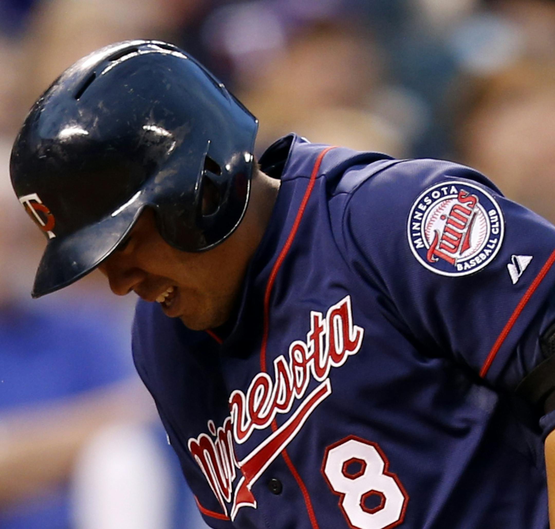 Minnesota Twins' Kurt Suzuki reacts after hitting a foul ball off against the Colorado Rockies during the fifth inning of a baseball game on Friday, July 11, 2014, in Denver. (AP Photo/Jack Dempsey)