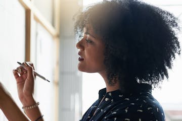 Shot of a young female designer working in her office