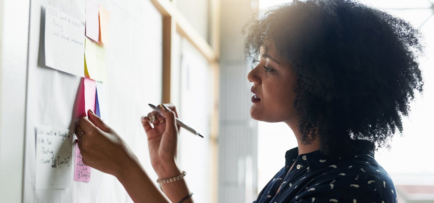 Shot of a young female designer working in her office