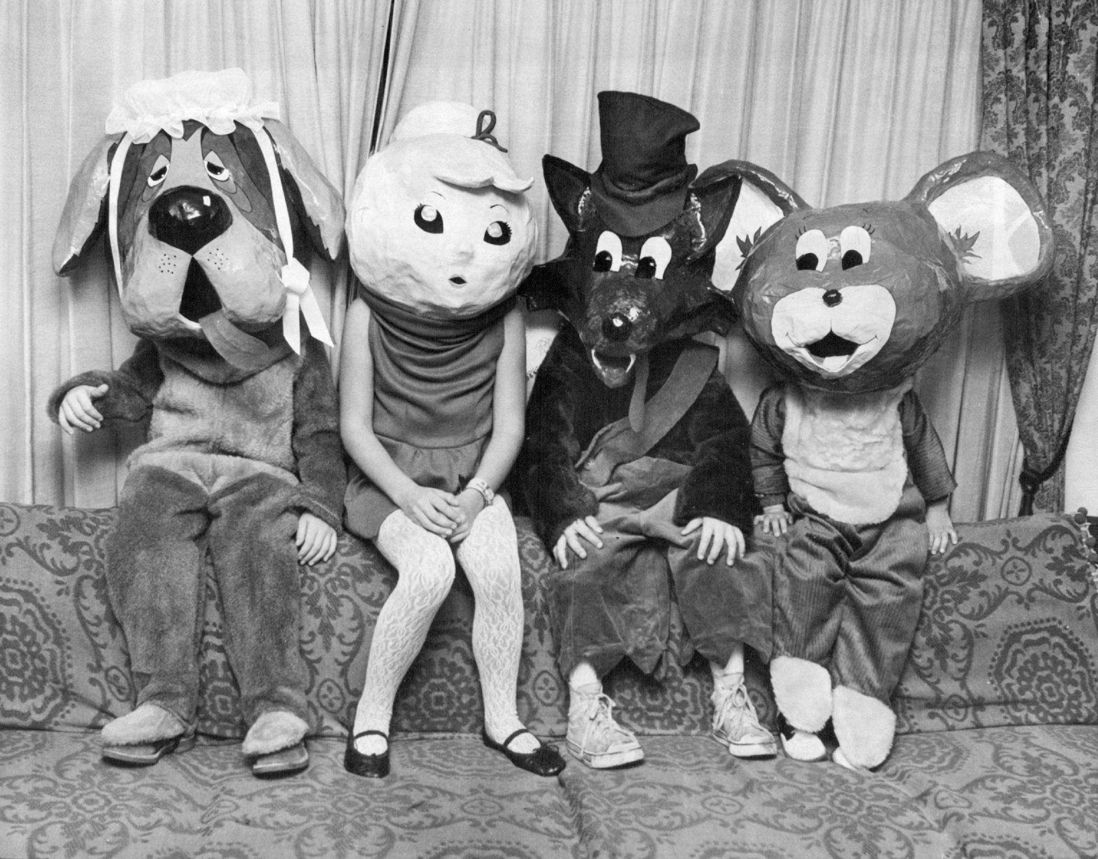 October 31, 1969 DRESS REHEARSAL FOR A TRICKS-OR-TREATS EXCURSION - Lets's do away with it all, readers suggest. FOR HALLOWEEN - The children of two suburban mothers will be well - disguised for their trick-or-treat expeditions tonight. Each child chose a character he wanted to be and then the women made masks of those characters out of papier-mache. The lightweight (only two to three pounds) mask rests on the child's shoulders. He looks out through the mouth. Mrs. Robert Wrobleski, 7137 Logan A