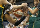 Maya Moore (23) fought for a rebound with three Seattle defenders in the second quarter.