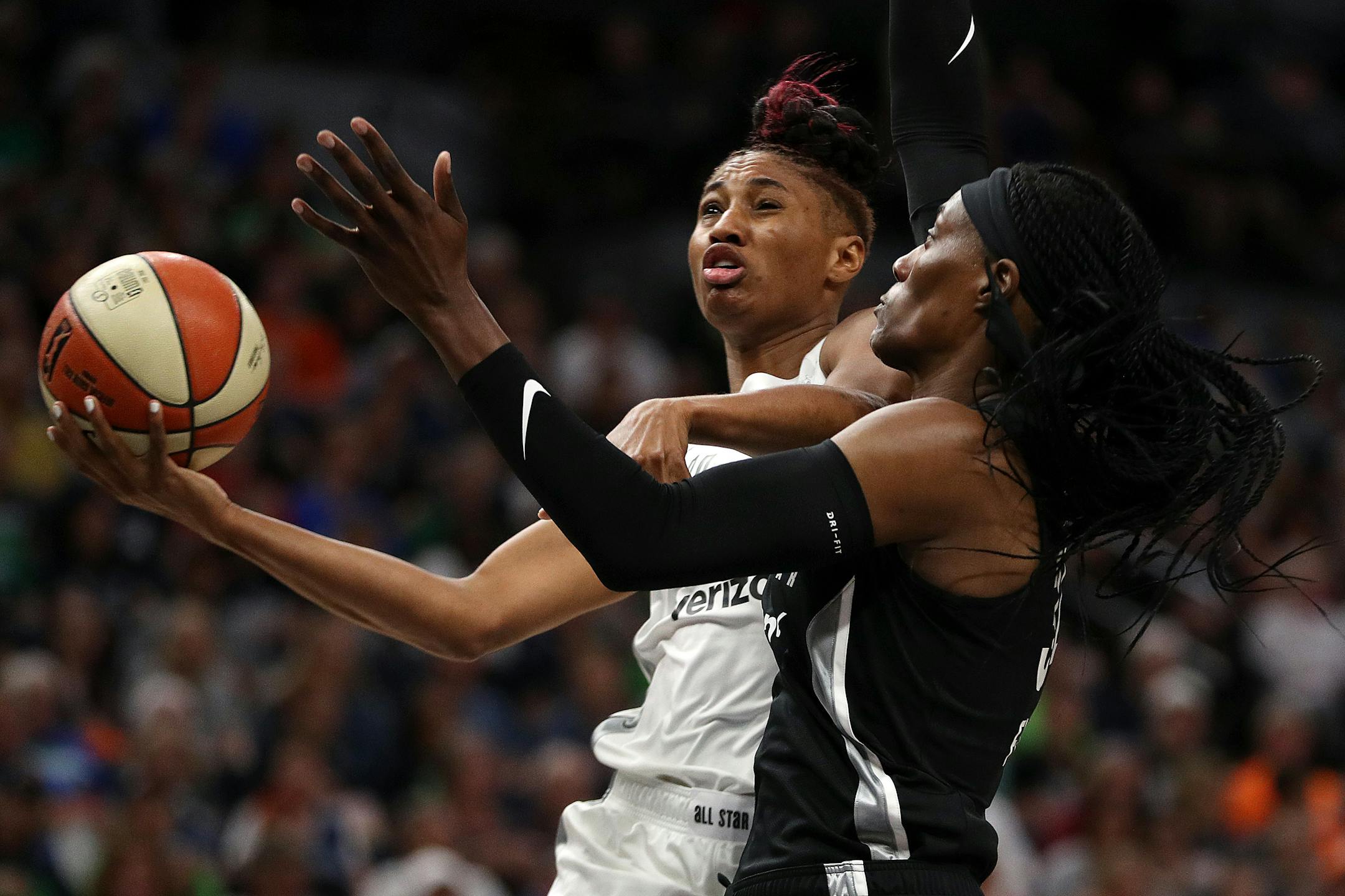Team Parker forward Angel McCoughtry (35) drove to the basket past Team Delle Donne center Sylvia Fowles (34) in the first half.