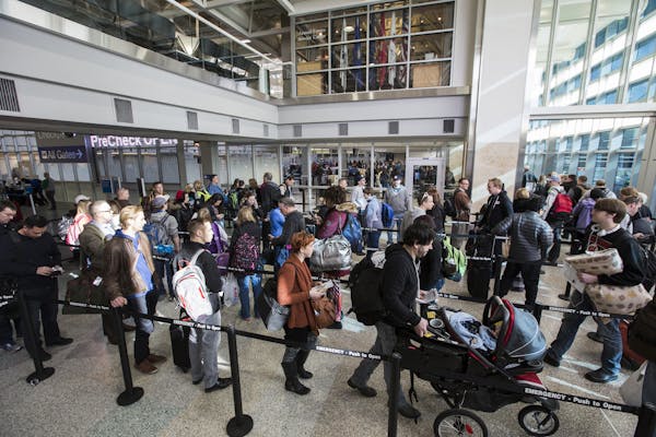 Passengers wait in line Friday to go through the new north security checkpoint at Terminal 1 of Minneapolis-St. Paul International Airport.