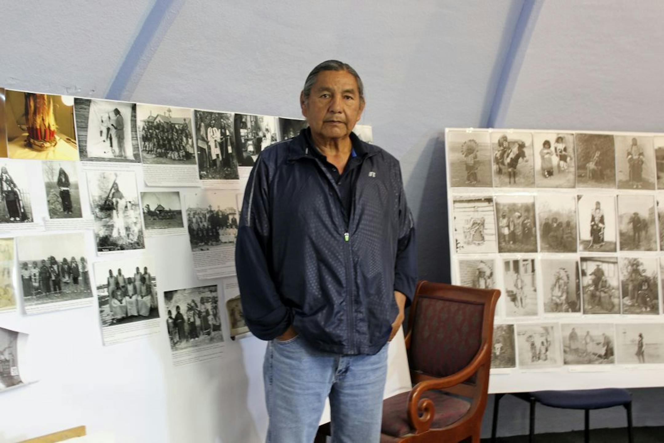 In this May 6, 2016, photo, Russell Eagle Bear, the historic preservation officer for the Rosebud Sioux Tribe, stands in his office in in Rosebud, S.D. Eagle Bear will be leading a meeting Tuesday, May 10 between leaders of several tribes, including the Rosebud Sioux Tribe, and representatives from the U.S. Army to address the possibility of repatriating the remains of at least 10 Native American children who died away from their homes while being forced to attend the government-run Carlisle Ind