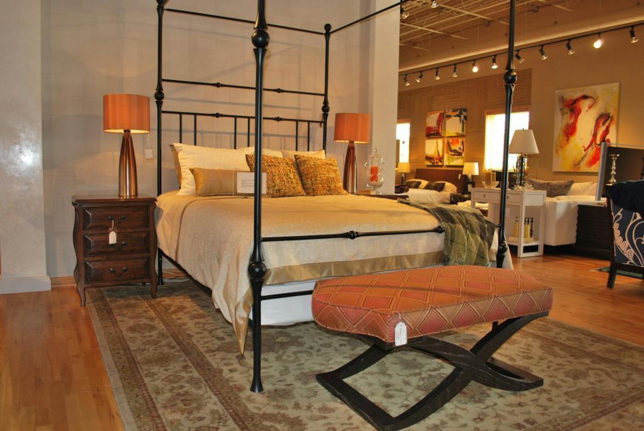 At Hirshfield's Design Studio sale, the bed is $2,200, bench
$900, nightstands $975 each, and lamps $225 each.