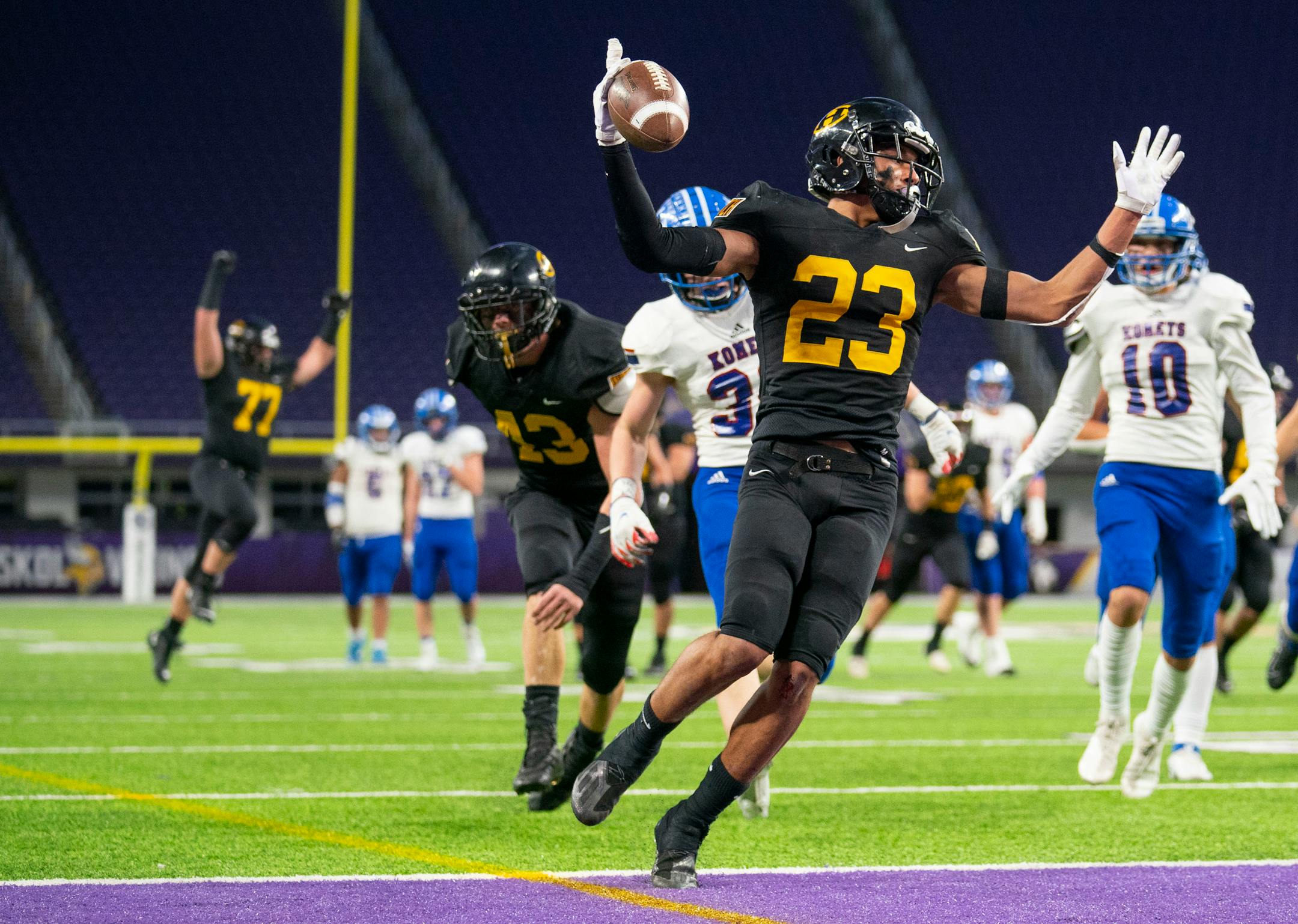 Hutchinson High School halfback Alex Elliot (23) celebrates after scoring the game's first touchdown against Kasson-Mantorville High School in the Minnesota High School football Section 4A State Championship Friday, Nov. 26, 2021 at U.S. Bank Stadium in Minneapolis. Hutchinson leads 28-7 at halftime. ]