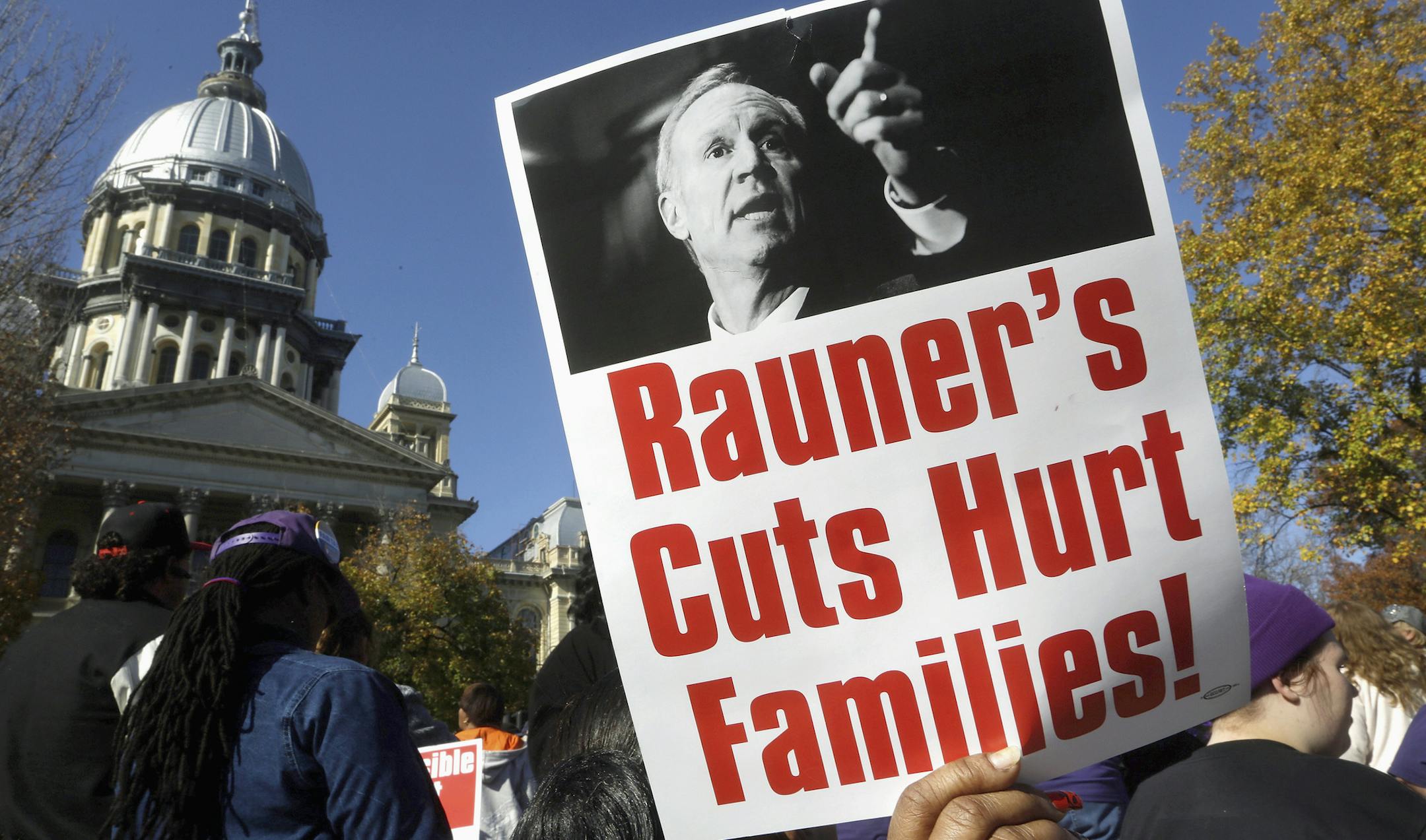 FILE - In this Nov. 10, 2015 file photo, protesters rally in support of lawmakers ending the state budget impasse at the Illinois state Capitol in Springfield. Gov. Bruce Rauner takes pride in not being like any of Illinois’ previous governors. Unlike even his Republican predecessors, who often cut deals with Democrats and their labor union allies in the Legislature, Rauner brags about being the first to stand up to them, even as it’s led to a record-breaking stalemate. Seven month