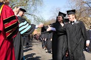 Connor Doebbert and Anne Dierberger, both English majors, were shaking hands with the professor, George Dierberger, before the commencement.
