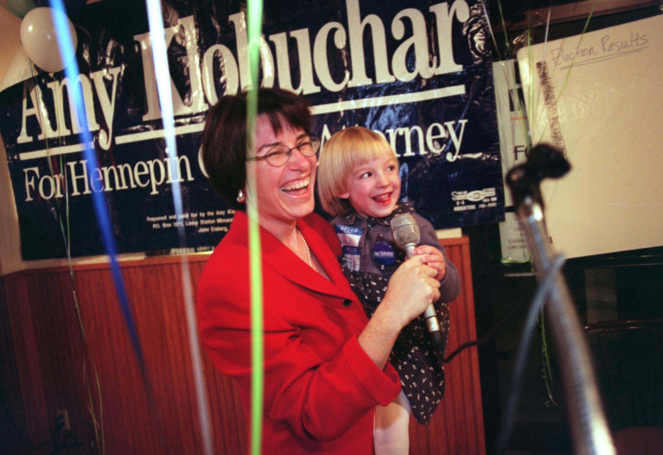 Election night coverage of Amy Klobuchar -- Hennepin County Attorney candidate Amy Klobuchar holds her daughter Abigail, 3 during Election night at Kramarczuk restaurant late Tuesday night. The race between Klobuchar and Hvass was close all night long. Seconds after the photo was taken Abigail vomitted on her mothers shoulder. Klobuchar then changed into another outfit.