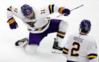 Minnesota State's Benton Maass (11) celebrates in front of teammate Akito Hirose (2) after scoring during the second period of an NCAA men's Frozen Fo