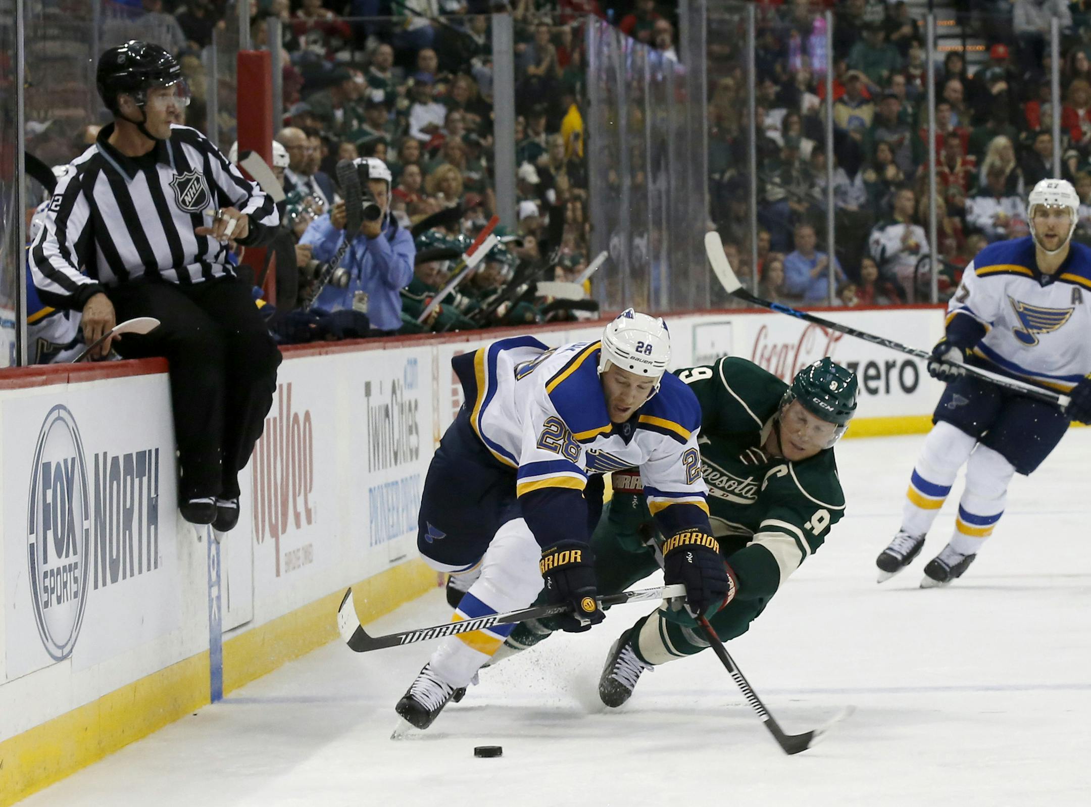 St. Louis Blues center Kyle Brodziak (28) and Minnesota Wild center Mikko Koivu (9), of Finland, fall as they battle for the puck during the second period of an NHL hockey game in St. Paul, Minn., Saturday, Oct. 10, 2015. (AP Photo/Ann Heisenfelt) ORG XMIT: MNAH106