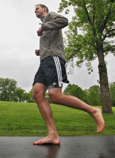 Christian Peterson runs barefoot on a Weaver Lake Park trail.