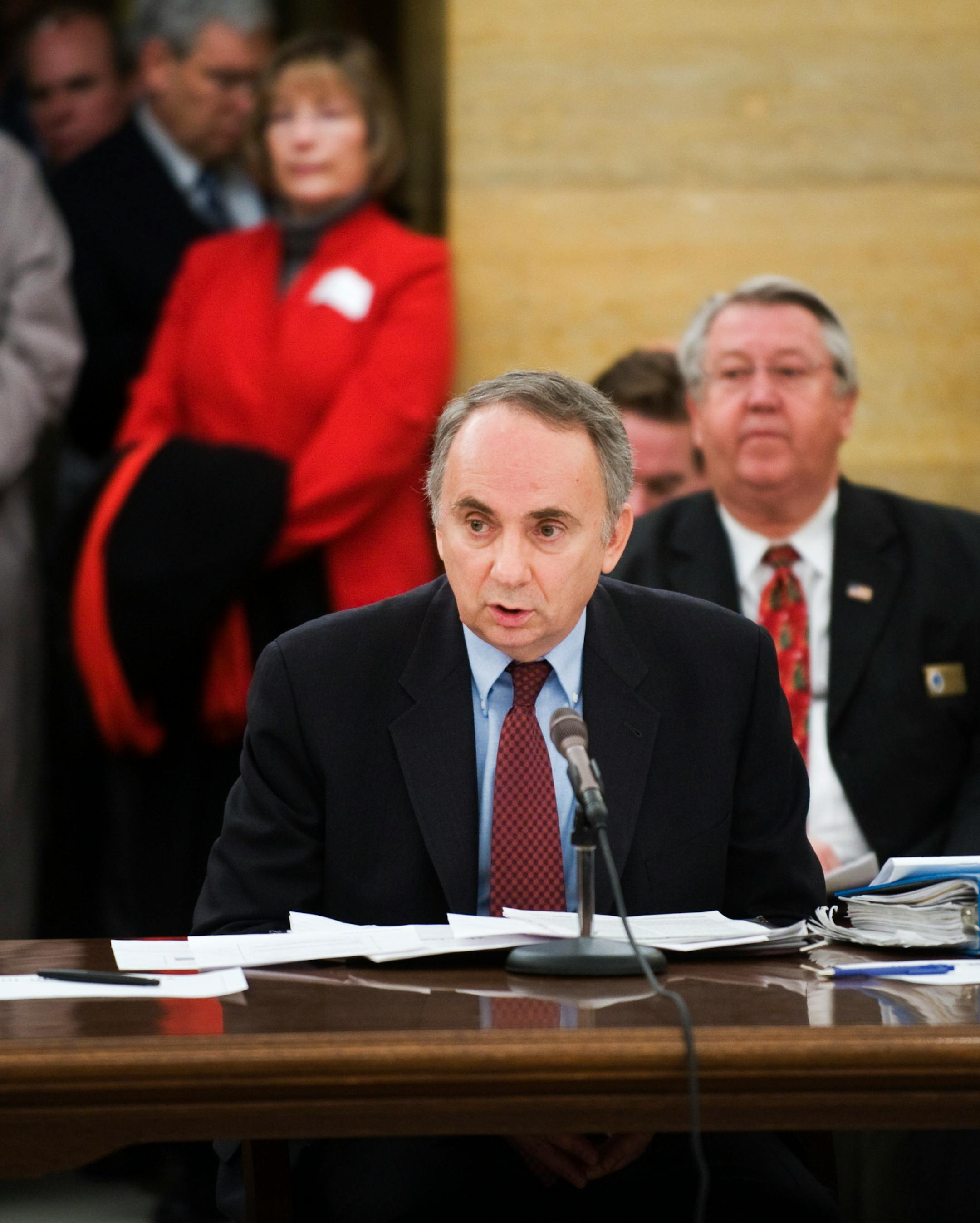 State economist Tom Stinson reported to the Senate Tax Committee that the state fiscal deficit is now projected to be higher than previously thought.