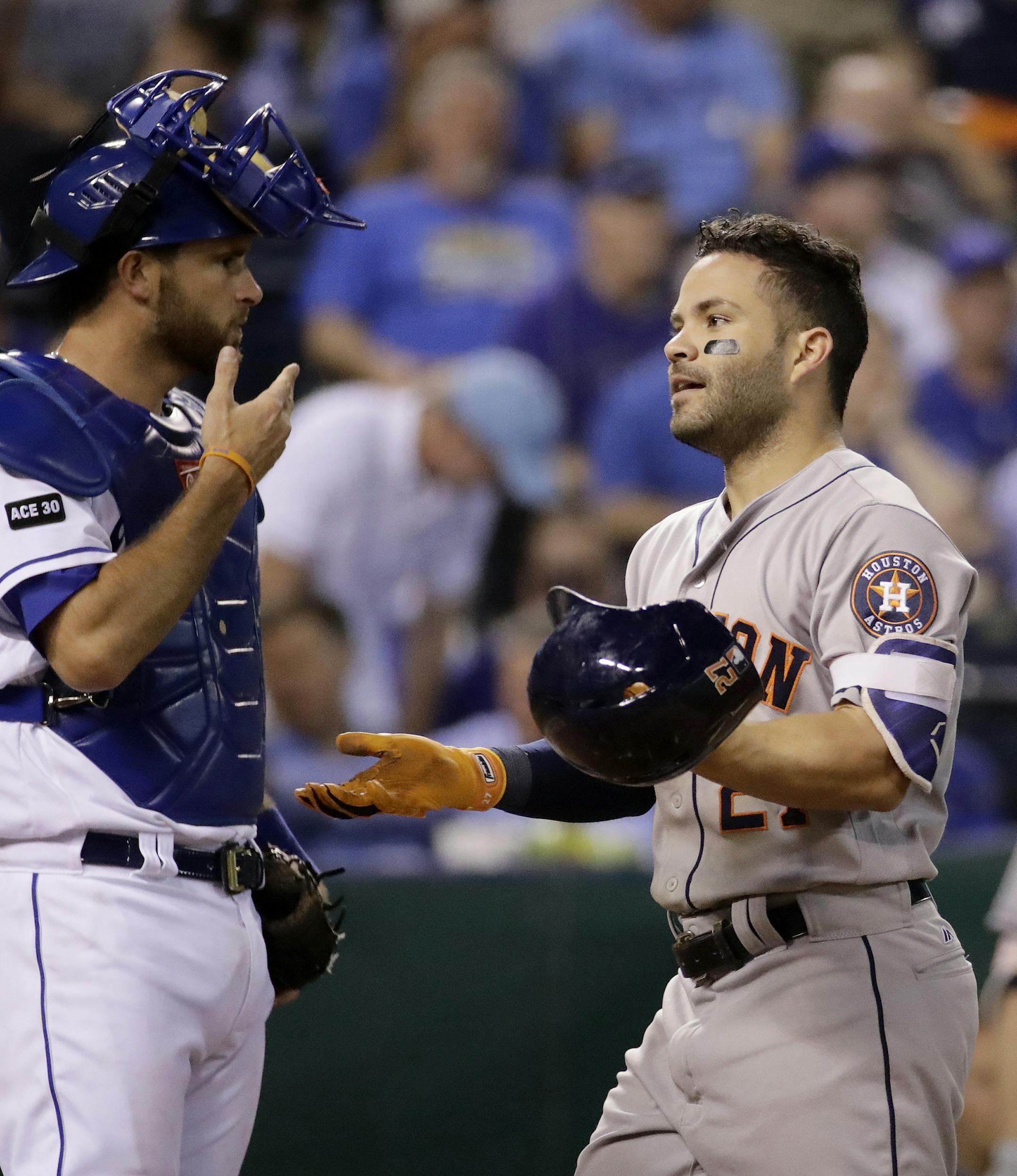 Houston Astros' Jose Altuve crosses the plate in front of Kansas City Royals catcher Drew Butera after hitting a two-run home run during the ninth inning of a baseball game Thursday, June 8, 2017, in Kansas City, Mo. The Astros won 6-1. (AP Photo/Charlie Riedel)